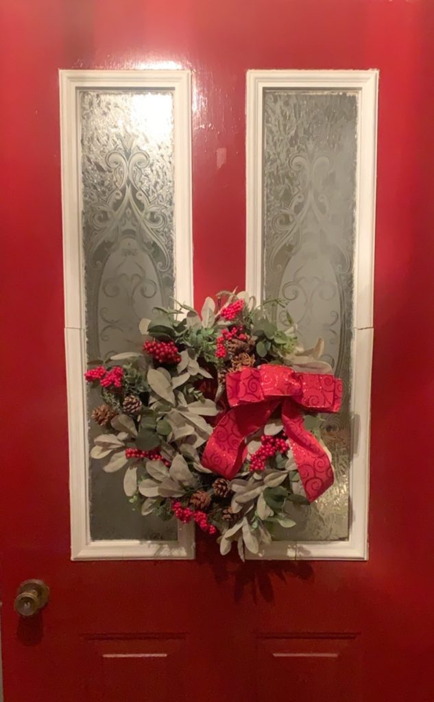 This image has an empty alt attribute; its file name is wreath-on-door-633x1024.jpg